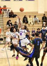 Trayvon McGraw, #21, drives over a Middie defender on his way to the basket.