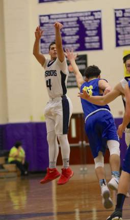 Photos by William Dimmit Rob Vacco (#4) led the Crusaders with 15 points against the Washingtonville High School Wizards.