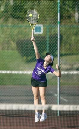 Adrianna Vacca gets off a big serve in her singles match.