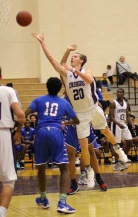Photos by William Dimmit Crusader John McCormick (#20) slices through the Middies for two points.