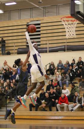 Photos by William Dimmit Jayson Ongondo (#1) provided a spark with this one-handed dunk in the second quarter.