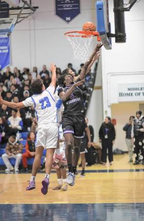 Fabrice Ndja, #3, drives through the Middletown defenders.