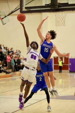 Fabrice Ndja, #00, takes the ball to the basket in the third quarter.