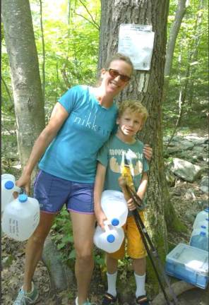 Edie Sonne Hall and her son Alder taking water to the Appalachian Trail when visiting in Tuxedo.