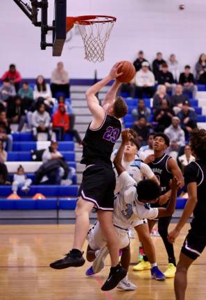 Crusader Kyle McDermott, #23, powers his way to the basket against the Mounties.