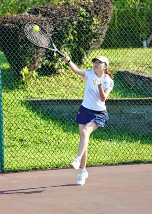 A Crusader tennis player practices as the fall sports season starts.