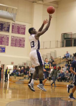 Photos by William Dimmit Brandon Adams (#13) hits a jump shot in the first quarter.