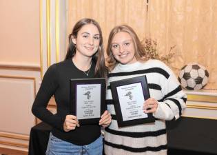 Kate Allen (left) and Samantha Key (right) hold up the Coaches Awards they were given at the soccer dinner earlier this year.