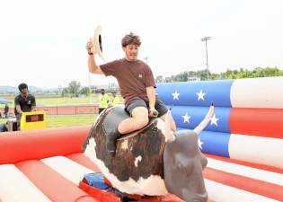 Senior Dominick Cosenza rides the mechanical bull.