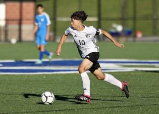 Neptaly Castro, #10, brings the ball up field against the Middies.