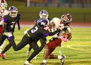 Crusader Louis Meade, #3, tackles a Tiger late in the game.