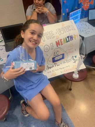 Pine Tree fifth grader Isabella M. Gonzalez with her project “The Future of Health.”