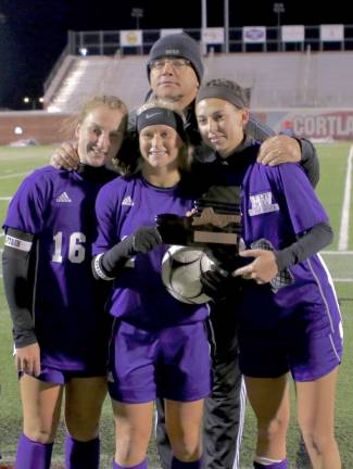 Head Bill Mpasiakos with team captains Liz Myers, Kayla MacKenzie and Kaitlyn Hogan as they receive their Final Four trophy after the game.