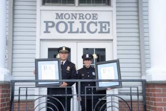 Police Chief Darwin Guzman and police officer Melissa Berke hold their proclamations.