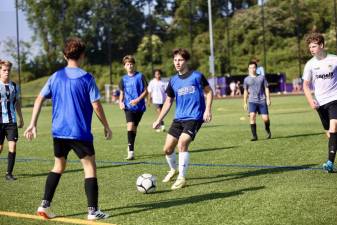 The boys’ soccer team working on passing drills.