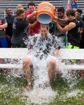 Monroe-Woodbury High School Principal David Bernsley accepts the Ice Bucket Challenge from members of the football team.