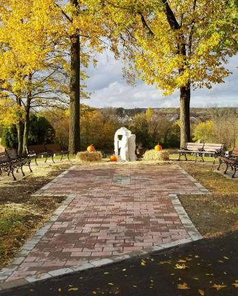 The completed project includes the memorial engraved paver patio, several benches and a statue of Christ on a hill overlooking the St. Anastasia cemetery.