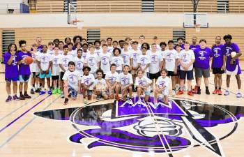 Crusader basketball campers and counselors pose for a photo at the end of a fun week.