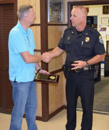 Provided photo Harriman Village Police Chief Daniel Henderson presents a retirement shield to Officer Johhny Motz at Tuesday's Village of Harriman board meeting.