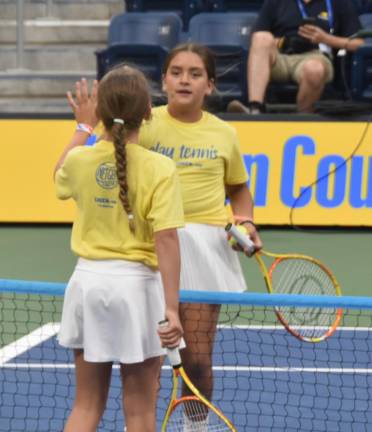 Players high-fiving at the net.