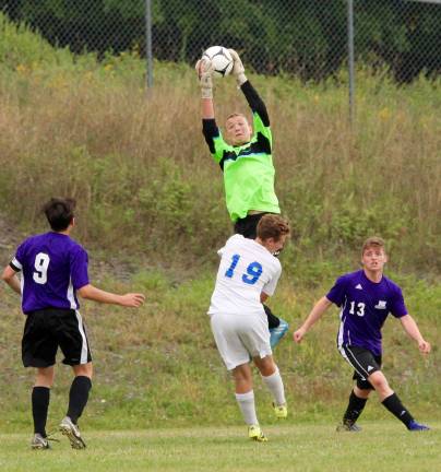 Photo by William Dimmit Crusader Goalie Dylan McDermott, shown here making a save earlier this seasson against Goshen, is this week's Monroe-Woodbury High School &quot;Athlete of the Week.&quot;