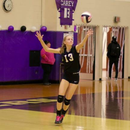 Photos by William Dimmit Strong play at the net by senior Dana Carey #13) helped the Crusaders in their comeback victory.