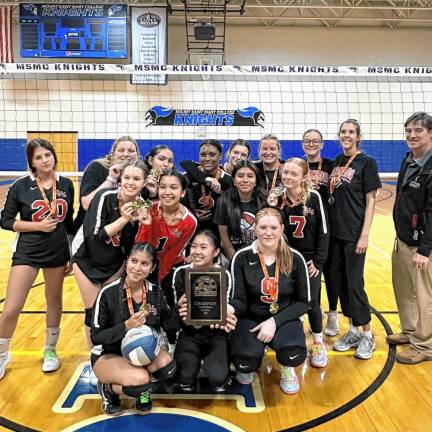 The volleyball team celebrates their championship win.