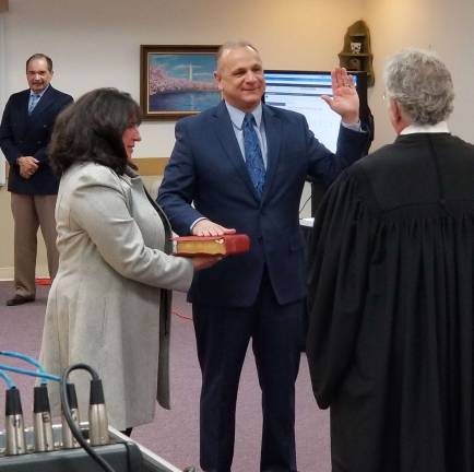 Photo by John AllegroMonroe Town Justice Steven Milligram administers the oath of office to Monroe Town Supervisor Anthony P. Cardone III.