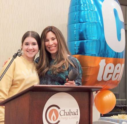 Chana Burston congratulates CTeen Haley Olstein of Monroe for sharing her perspectives on being a CTeen leader at Chabad of Orange County’s CTeen Lounge ribbon-cutting.