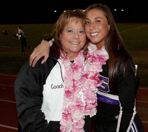 Cheerleading Coach Barbara AliDad and Senior Captain Olivia Torres share a moment.