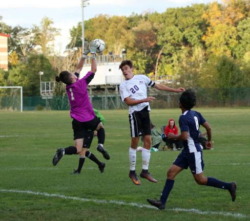 Photos by William Dimmit Kevin Grimes (#20) tries to head the ball past the Newburgh goalie in the second half.