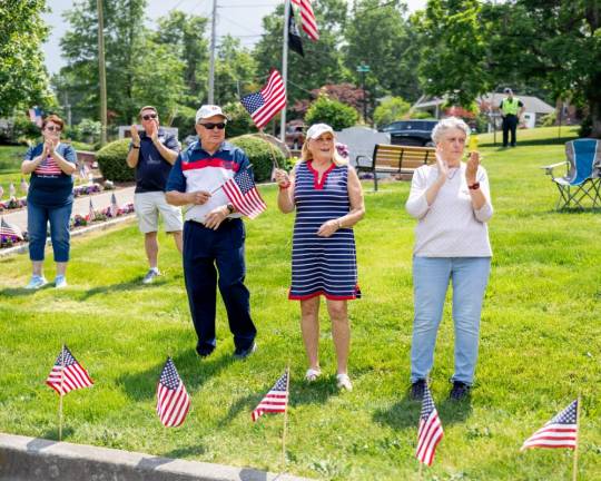 Locals wave flags in support of those marching in the annual Memorial Day Parade in Monroe. Photos by Sammie Finch