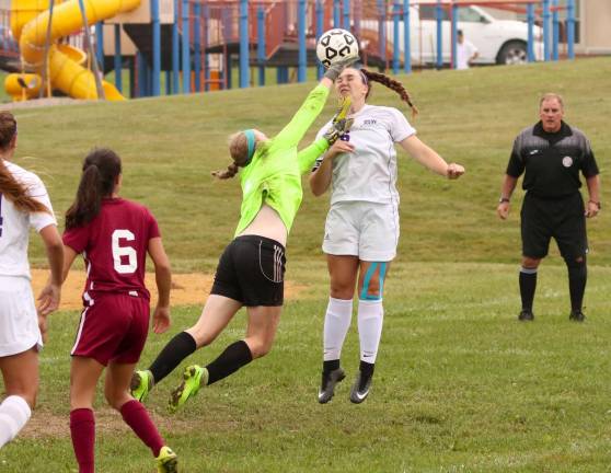 Photos by William Dimmit Crusader Liz Myers (#16) trys to head the ball past the Kingston goalie.