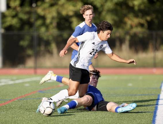 Crusader Nicholas Almeida, #23, gets denied the ball by a diving Gladiator defender in front of the Goshen goal.