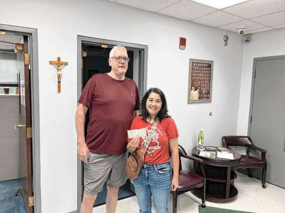 Monroe AOH Hunger Project Chairman Bill Coffey presents a check to Parish Outreach Director Kimberly Gutman.