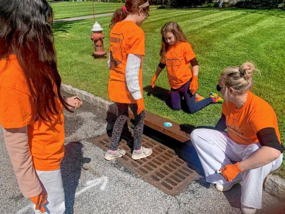 A sticker on the catch basin informs residents that whatever flows into this end may empty out into a local water source.