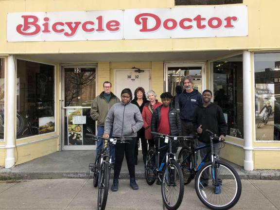 At the Bicycle Doctor, from the left: Don Karlewicz, club treasurer; Devonna Patterson, a bicycle recipient; Pastor Rosey Andrews of Northeast Gateway to Freedom; Peggy Cullen, club vice president; Willie Bryant, a bicycle recipient; Rich Cruet, owner of The Bicycle Doctor; and Michael Lawrence, bicycle recipient.