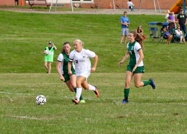 Kayla MacKenzie (#2) splits the Dragon defense and and scores late in the game to give the Crusaders the 1-0 victory.
