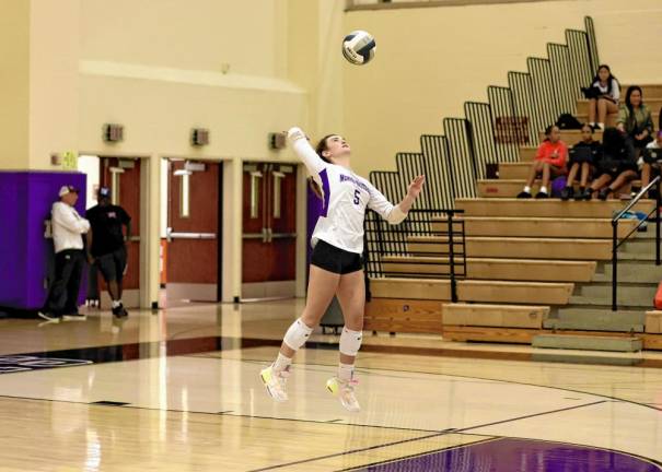 Briann Grove, #5, serves in the first set.