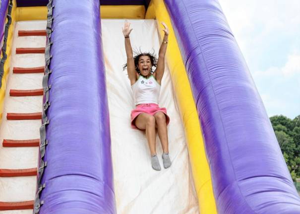 Senior Brianna Rivera has fun on the bouncy house slide.