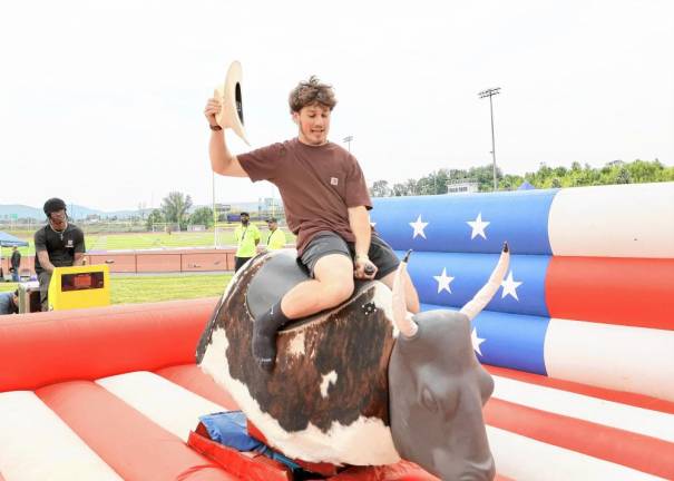 Senior Dominick Cosenza rides the mechanical bull.