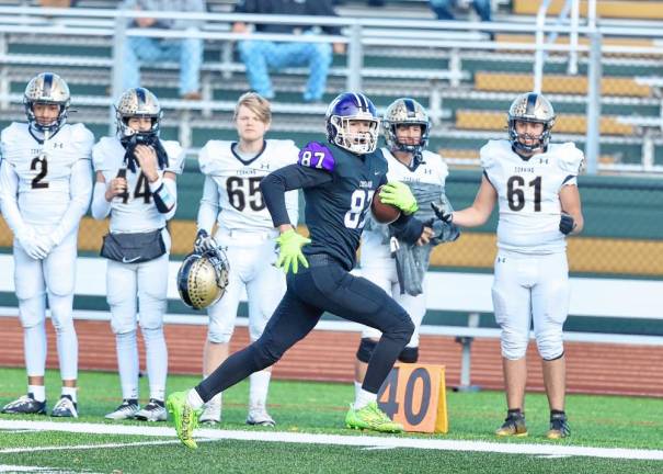 Charlie Theokas, #87, streaks down the far sideline for a 58-yard gain in the third quarter.