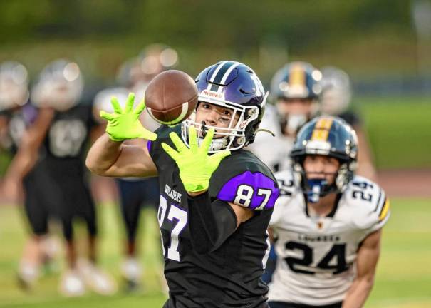 Charlie Theokas, #87, hauls in a 50-yard pass to put the Crusaders in scoring position just before the half.