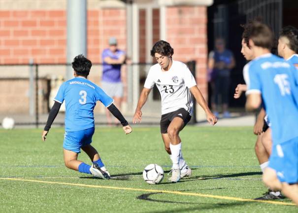 Nicholas Almeida cuts between two Middie defenders before scoring in the second half.