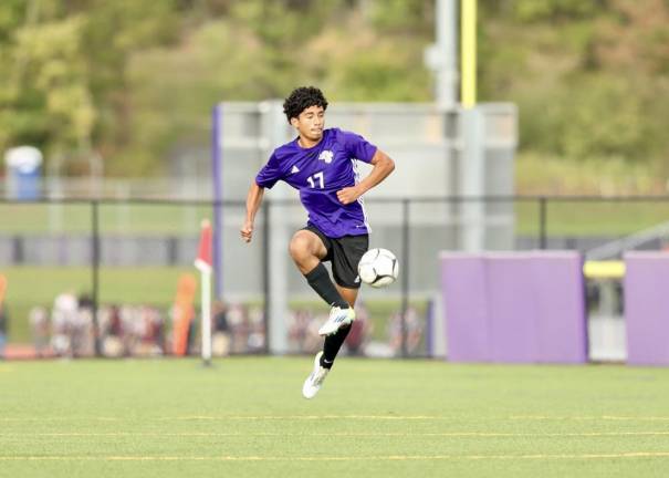 Melvin Hernandez, #17, takes the ball out of the air near midfield.