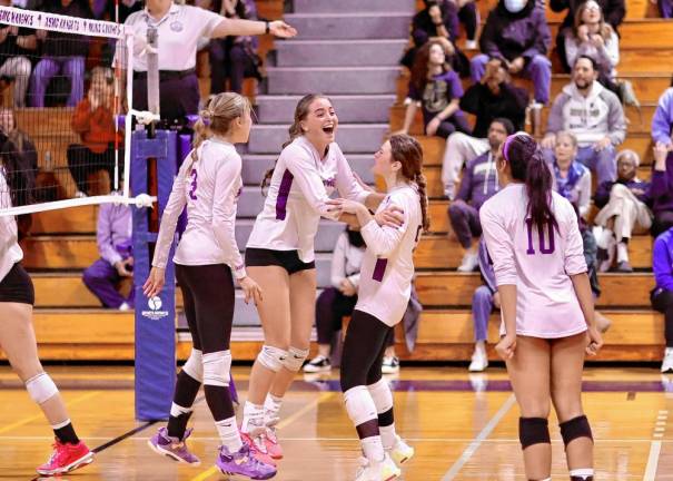 The Crusaders celebrate their second set comeback victory.