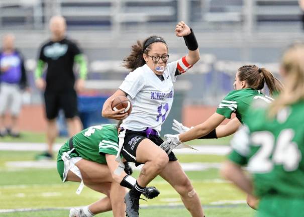 Crusader quarterback Chloe Ahorrio cuts through the Warrior’s defense.