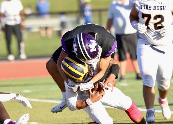 Crusader linebacker Roland Chambers, #26, sacks the Bushmen’s QB for a loss in the fourth quarter.