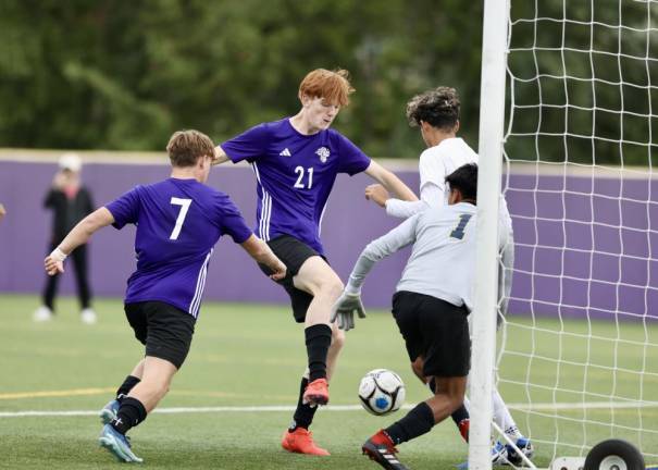 Liam McGee, #21, scores off a corner in the first half.