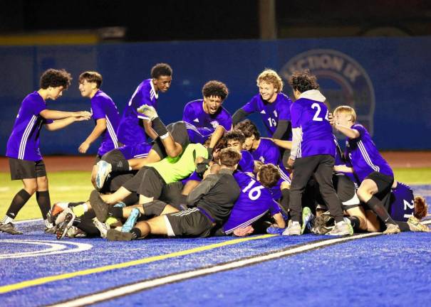 Crusaders mob Ortiz after his penalty kick gave the Crusaders the Section 9 title.